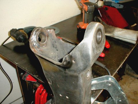 1996 Ford Bronco - A close-up view of a metal suspension part that has undergone welding repairs.