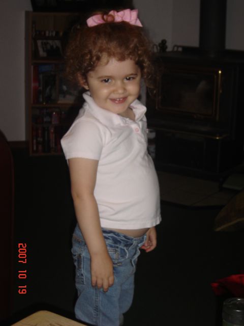 1993 Ford Bronco - A young child with curly hair and a pink bow smiles for the camera.
