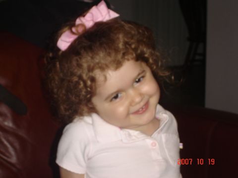 1993 Ford Bronco - Child with curly hair and a pink bow smiles for the camera.