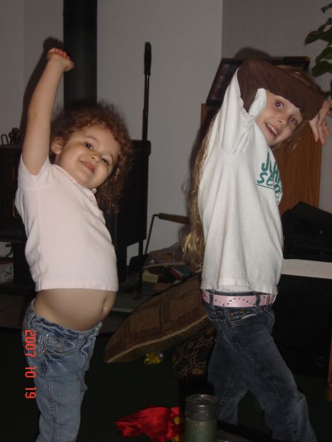 1993 Ford Bronco - Two children strike a pose in front of a wood stove and furniture.