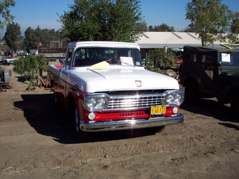 1981 Kenworth W900A - A two-tone red and white pickup truck is parked outdoors on a sunny day.