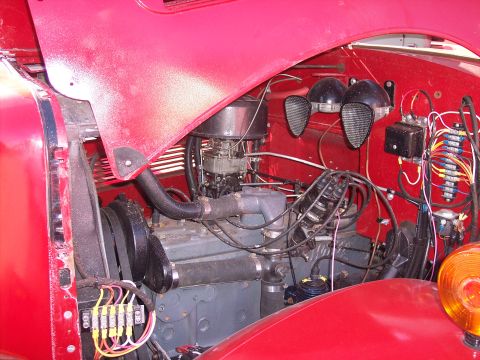 1981 Kenworth W900A - Close-up view of a red truck's engine bay, showing the engine components and wiring.