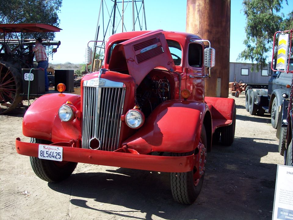Red vintage White Super Power truck with hood open showing engine at outdoor display