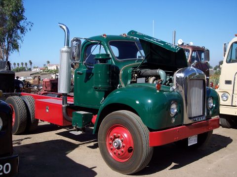1981 Kenworth W900A - A green semi-truck with its hood open, showing the engine compartment.