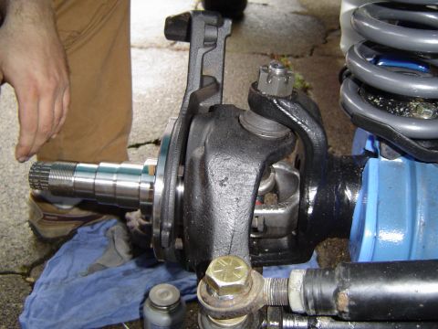 1978 Ford Bronco - Close-up of a vehicle's front axle hub and spindle assembly during a repair or modification.