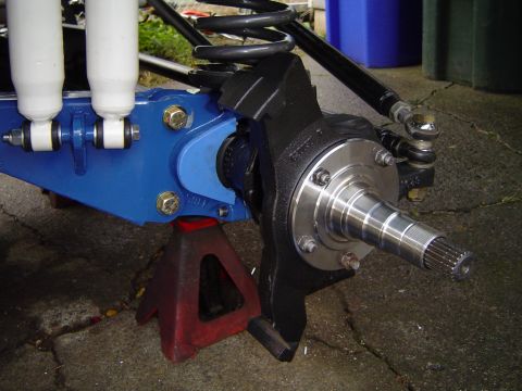 1978 Ford Bronco - Close-up of a vehicle's front suspension assembly, showing modified components and shock absorbers.