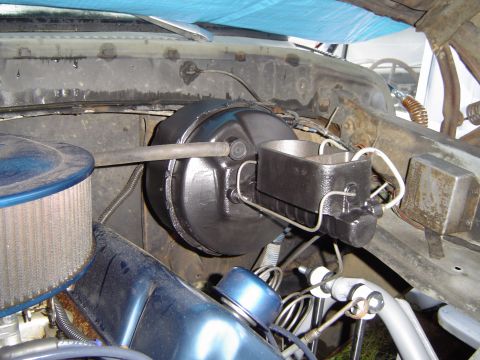 1978 Ford Bronco - Close-up view of the brake booster and master cylinder in a vehicle's engine bay.