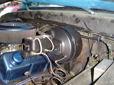 1978 Ford Bronco - Close-up of a vehicle's engine bay showing the brake booster and master cylinder.