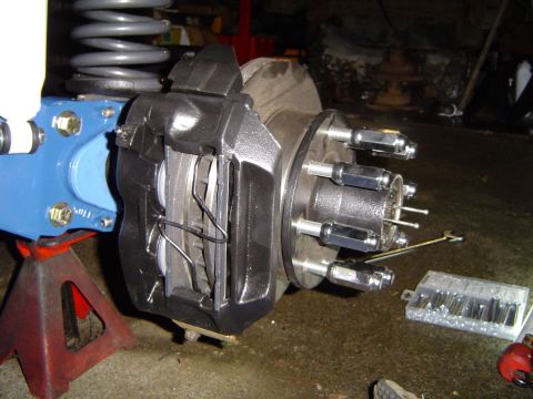 1978 Ford Bronco - Close-up of a vehicle's brake caliper and rotor assembly, likely during a repair or upgrade.