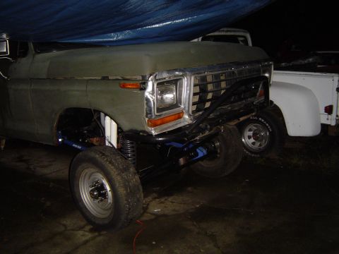 1978 Ford Bronco - This lifted truck features a custom front bumper and suspension modifications, with a second vehicle partially visible in the background.