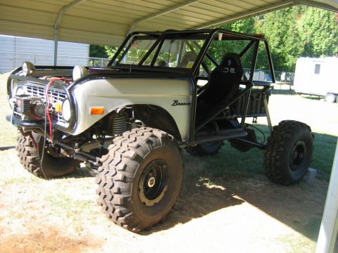 1992 Ford Mustang - This heavily modified Ford Bronco features a roll cage and oversized tires, suggesting it's built for off-road use.