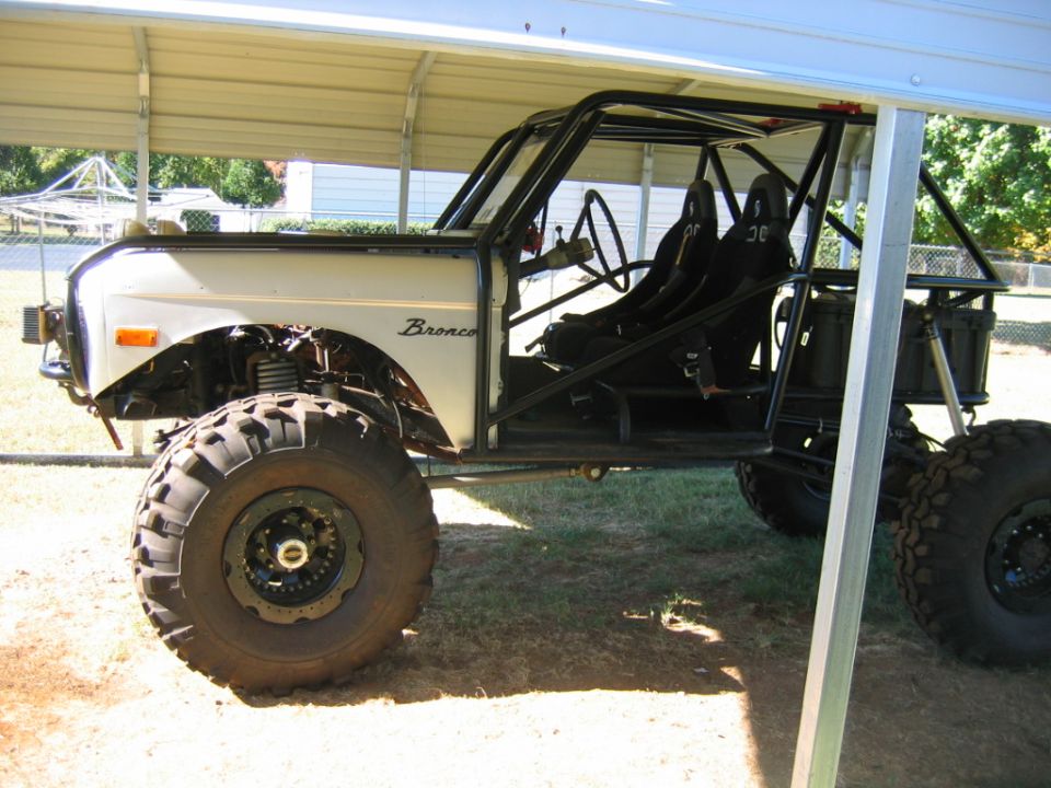 Side view of custom Bronco with roll cage and large tires