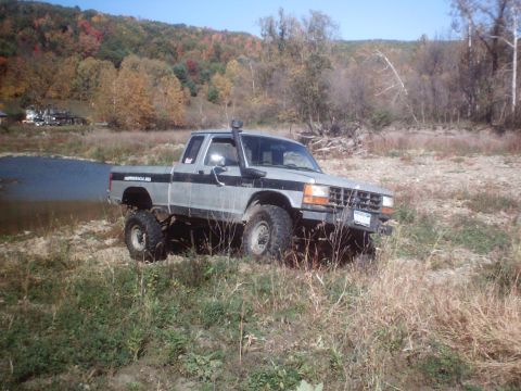 1990 Ford Ranger - This lifted 1990 Ford Ranger is equipped with a snorkel and parked near a body of water.