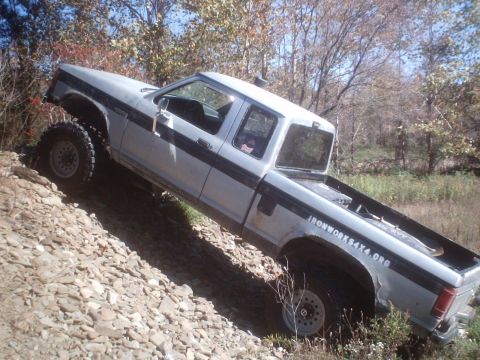 1990 Ford Ranger - A lifted 1990 Ford Ranger navigates a challenging rocky terrain.