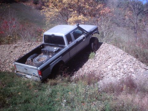 1990 Ford Ranger - Silver 1990 Ford Ranger pickup truck equipped for off-roading on a gravel hill.