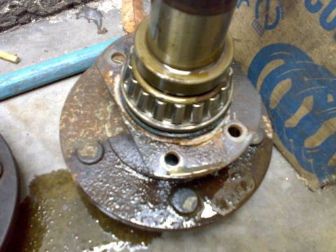 1995 Ford F-150 - Close-up of a rusty wheel hub and bearing assembly, likely undergoing repair or maintenance.