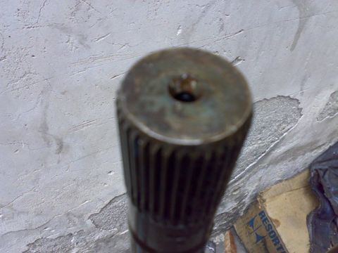 1995 Ford F-150 - A close-up view of a splined axle shaft, likely a component from a vehicle's drivetrain.