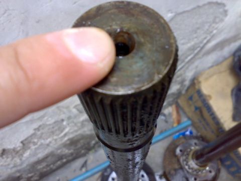 1995 Ford F-150 - Close-up of a splined shaft end with a finger pointing to it. Other parts are visible in the background.