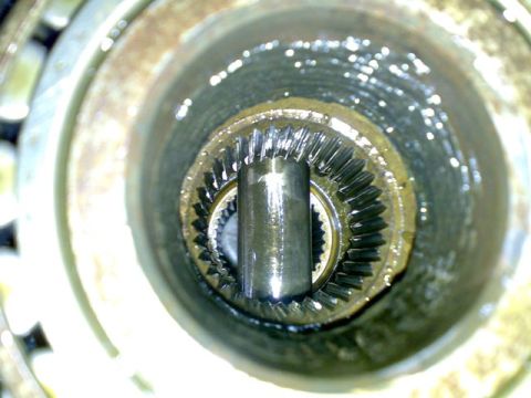 1995 Ford F-150 - Close-up view of the splined end of a differential axle, coated in grease.