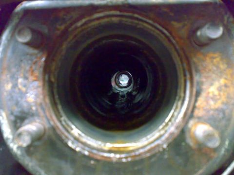 1995 Ford F-150 - Interior view of a corroded metal tube, possibly part of a vehicle's axle assembly.