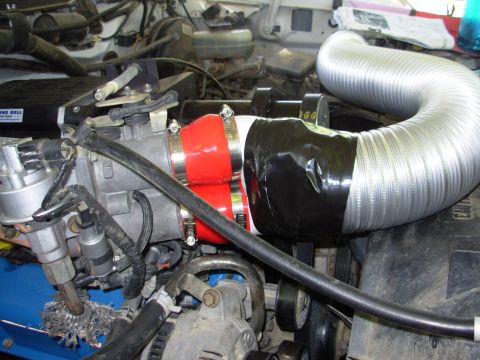 1994 Ford Bronco - Custom intake tubing with red coupler and black tape is visible in the engine bay.