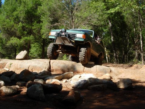 1995 Ford Bronco - This modified 1995 Ford Bronco navigates a challenging rocky terrain on an off-road trail.