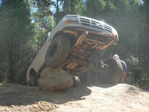 1995 Ford Bronco - This 1995 Ford Bronco is navigating a difficult obstacle on an off-road trail.