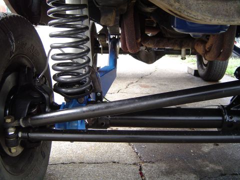 1978 Ford Bronco - Undercarriage view shows the heavy-duty suspension and steering system of a vehicle.
