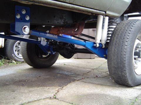 1978 Ford Bronco - Close-up view of modified suspension and drivetrain parts on a vehicle's undercarriage.