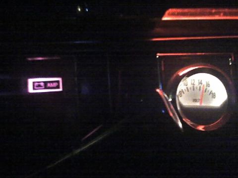 1985 Ford Crown Victoria LTD - Interior view of a vehicle dashboard, highlighting a voltage meter and an amp indicator light.
