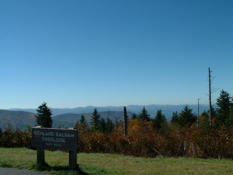1995 Ford Bronco - A scenic overlook sign is positioned in front of rolling hills and a clear blue sky.