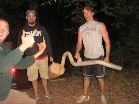 1986 Ford Bronco - Three men pose with a large exhaust pipe in a wooded area at night.