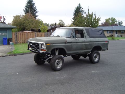 1978 Ford Bronco - This lifted 1978 Ford Bronco is equipped with a brush guard and a soft top, seen in a residential area.