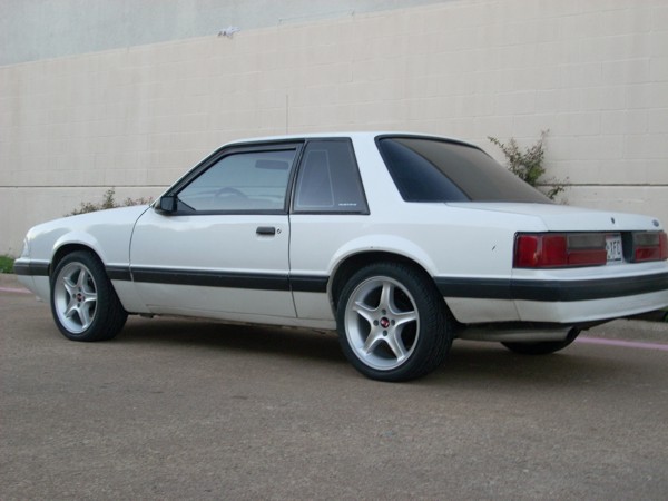 White 1991 Ford Mustang coupe, rear three-quarter view, aftermarket wheels