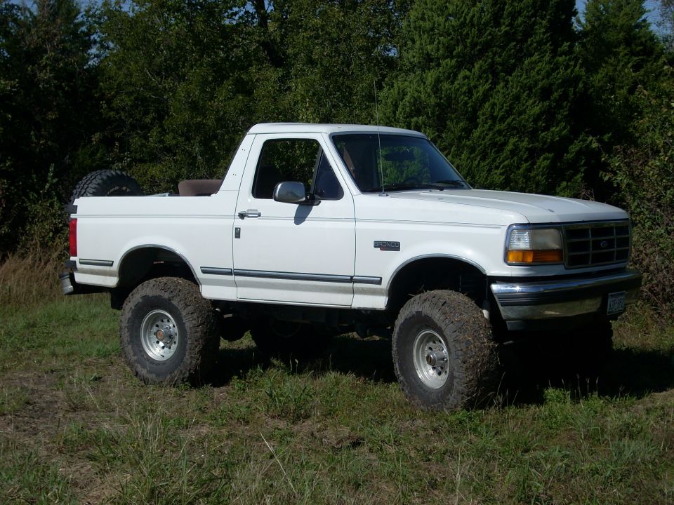 White 1992 Ford Bronco, 3q-front view, lifted with off-road tires