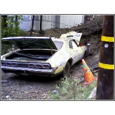 1971 Mercury Cyclone - This 1970 Chevrolet Camaro is seen from the rear with its trunk open, partially off a dirt embankment.