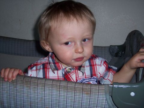 1972 Ford Ranchero - A young child with blond hair looks to the side while sitting in a crib.