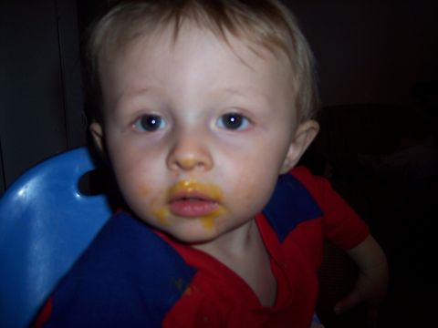 1972 Ford Ranchero - A young child sits in a blue high chair, their face smeared with orange food.