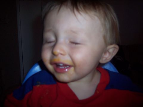 1972 Ford Ranchero - A young child with food on their face and eyes closed smiles.