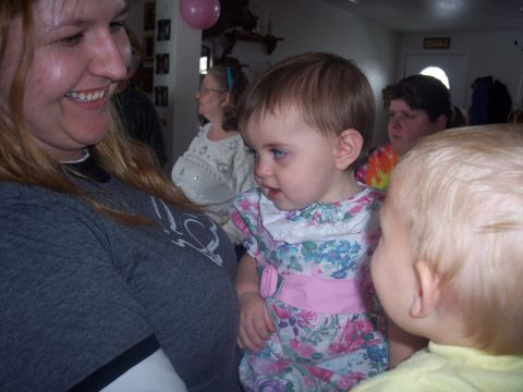 1972 Ford Ranchero - A group of people, including toddlers and adults, are gathered indoors, possibly for a celebration.