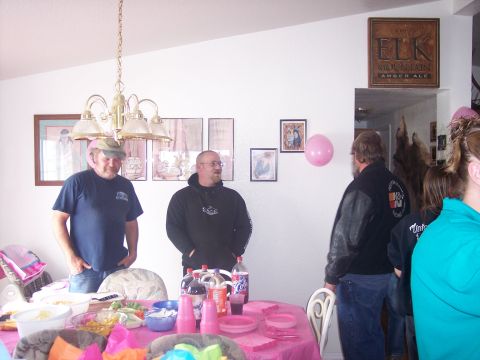1972 Ford Ranchero - People gather around a table with food and drinks, with decorations and framed pictures on the wall.