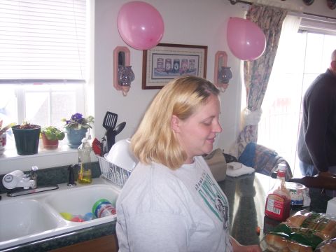 1972 Ford Ranchero - A woman stands in a kitchen with pink balloons and a sink full of dishes.
