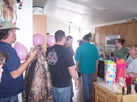 1972 Ford Ranchero - A group of people are seen in a room, with pink balloons and a camouflage jacket visible.
