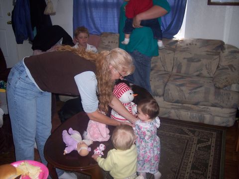 1972 Ford Ranchero - A group of people, including children and babies, are gathered in a living room around a coffee table.