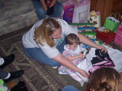 1972 Ford Ranchero - A group of people are gathered around opening gifts on the floor.