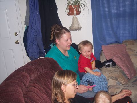 1972 Ford Ranchero - A family gathers on a couch, with a woman holding a toddler while another woman and baby are also present.
