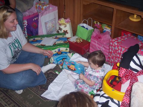1972 Ford Ranchero - A woman and a baby sit on the floor surrounded by many wrapped presents and gift bags.