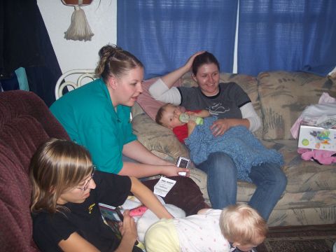 1972 Ford Ranchero - A group of people, including two babies, relax together in a casual indoor setting.