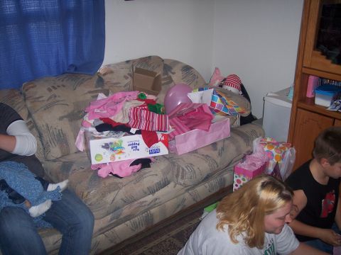 1972 Ford Ranchero - A couch is piled high with gifts and clothing, suggesting a celebration or a recent shopping trip.