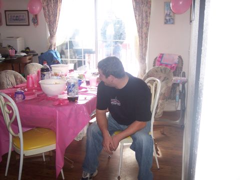 1972 Ford Ranchero - A man sits at a table set for a party, with pink decorations and drinks visible.